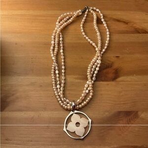 Honora: Mother of pearl flower pendant silver around it with 3 strand pearls.